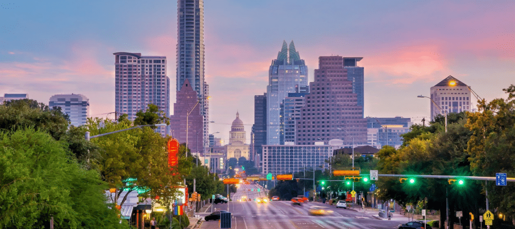 streetview of the capital building in the distance between skyrises in downtown Austin, texas