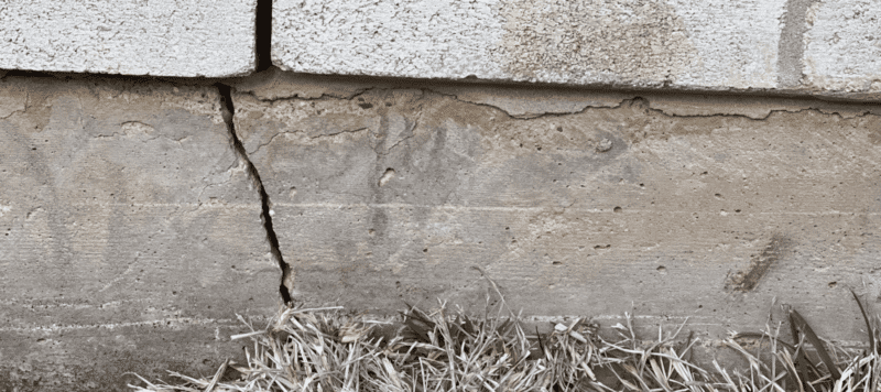 large crack in the concrete slab underneath a home