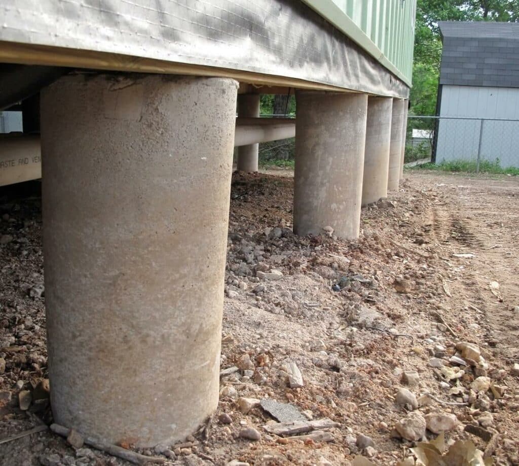 five concrete cylinders forming a south texas home's pier and beam foundation
