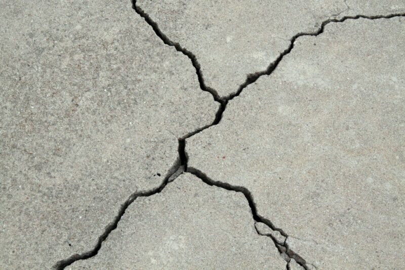 close up of an x-shaped crack in a concrete floor