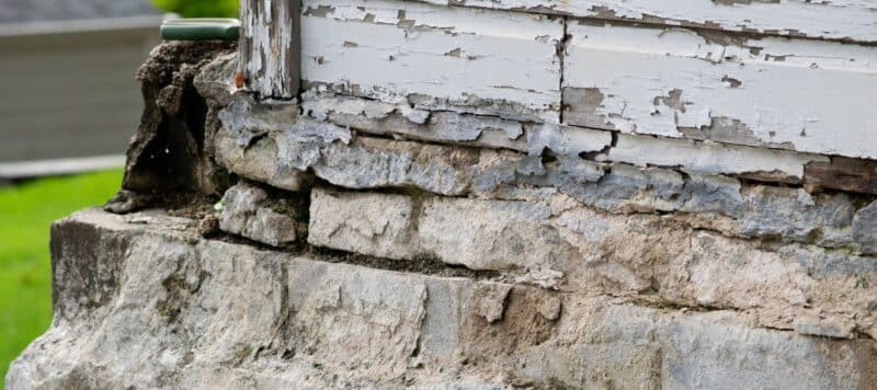 crumbling concrete along a home's foundation slab