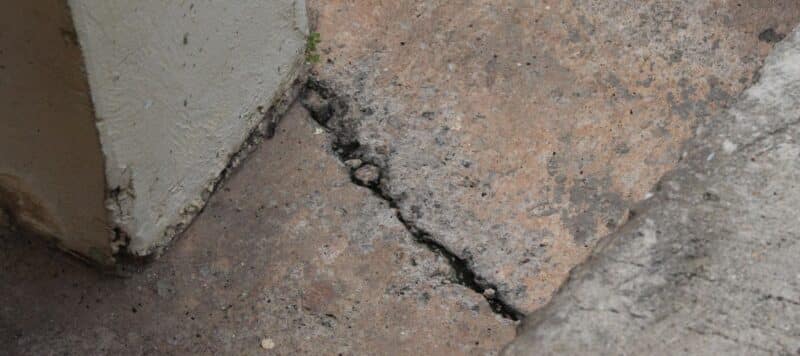 close up view of a crack in dark-colored concrete