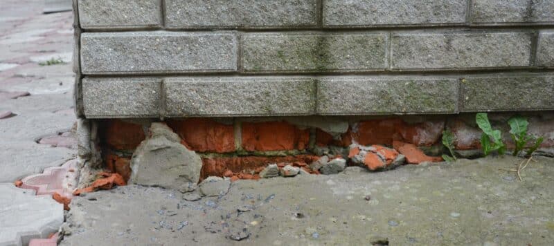 brick cracking near foundation on home, exposing masonry underneath