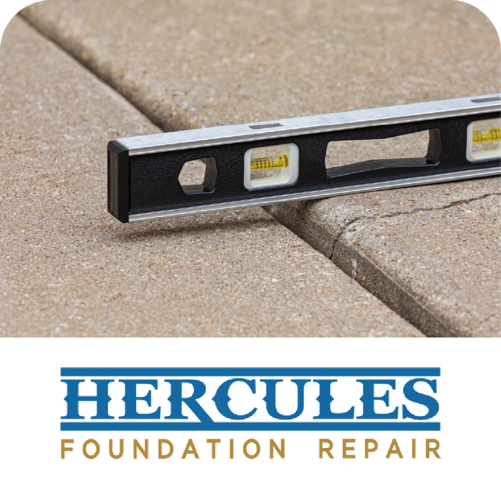 Level tool rests on uneven concrete slabs above the Hercules Foundation Repair logo